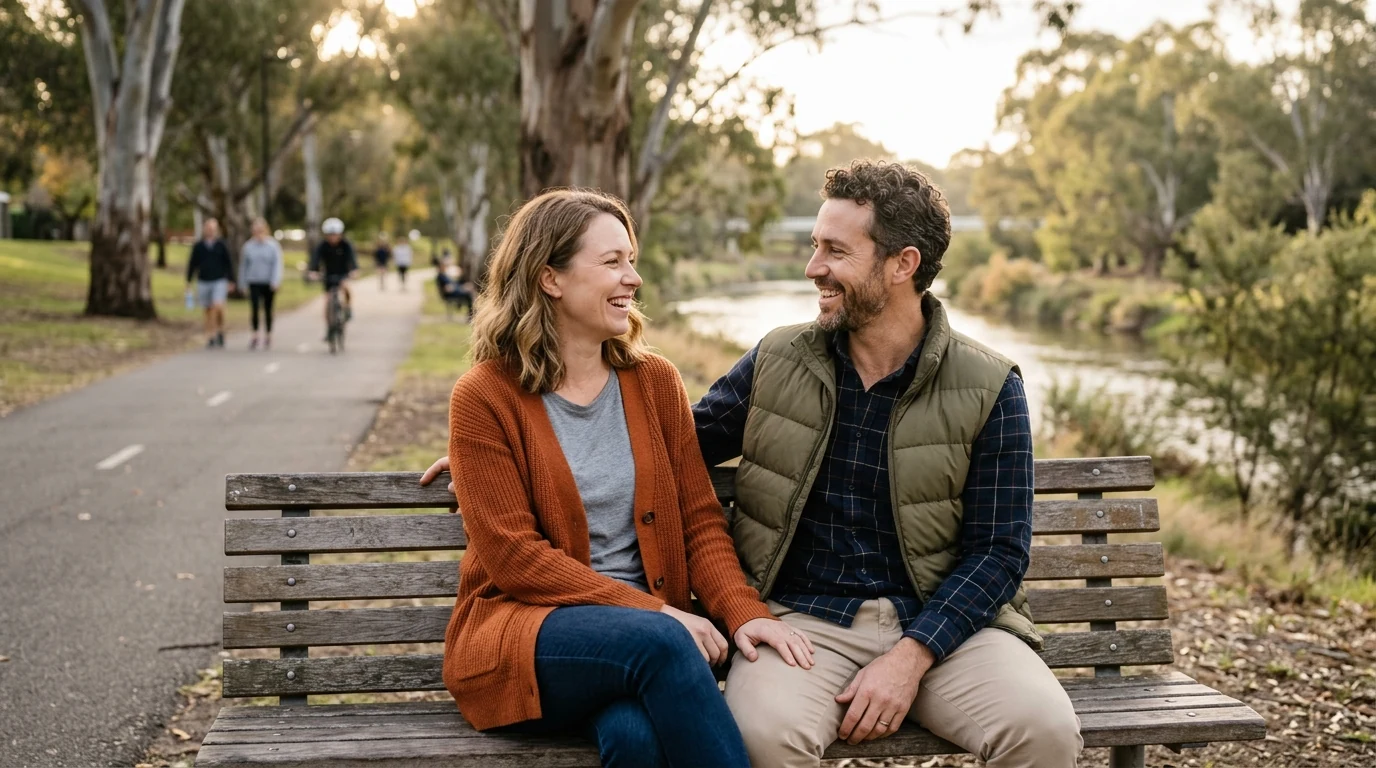 Couple talking on a bench on the Torrens Linear Park trail in Adelaide on a mild day